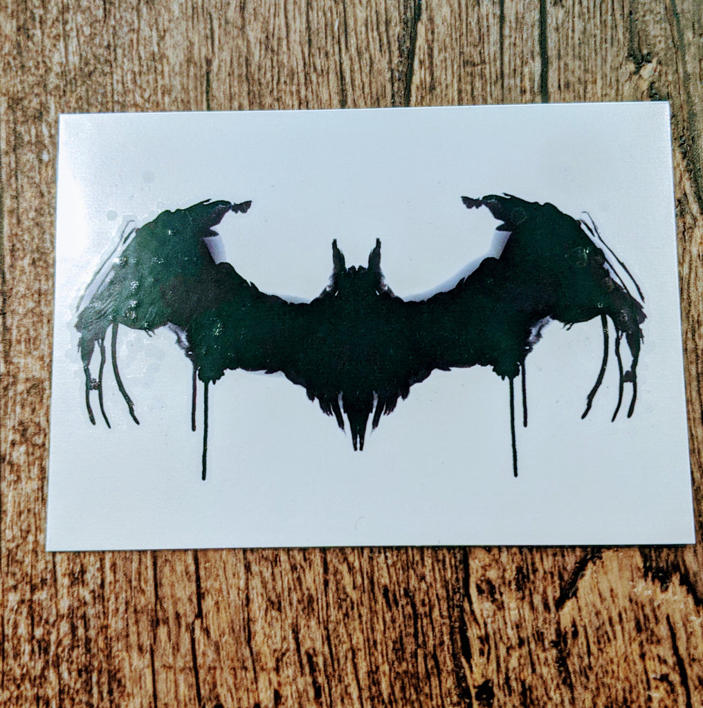 Batman logo on Cem's left ribcage.